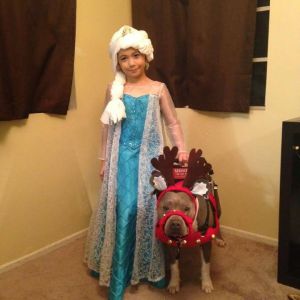 Abcde Santos, 7, is seen in a photo with her service dog, Pup-Cake. (Photo courtesy of the Santos family)