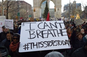 Protesters march on 5th Avenue during the Millions March NYC on Saturday, Dec. 13, 2014, in New York. Thousands of people marched in Washington and New York on Saturday to demand justice for black men who have died at the hands of white police, the latest in weeks of demonstrations across the United States. (Credit: Don Emmert/AFP/Getty Images)