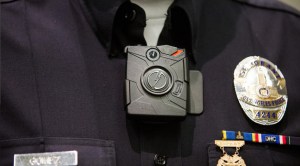 Sgt. Dan Gomez of the LAPD Tactical Technology Section wears the new TASER Axon on-body cameras meant for police officers during a Dec. 16, 2014, press conference where Mayor Eric Garcetti announced that the city would purchase cameras in an effort to increase transparency. (Credit: Marcus Yam / Los Angeles Times)