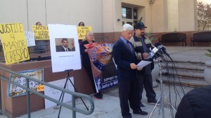 Attorney James Devitt speaks alongside William Crespo at a news conference outside the coroner's office in Boyle Heights on Dec. 19, 2014. (Credit: KTLA)