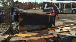 Residents were cleaning up after a small tornado struck South L.A. Dec. 12, 2014. (Credit: KTLA)