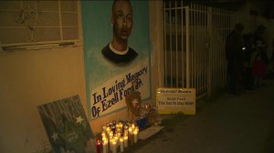 Candles and messages mark the spot where Ezell Ford was fatally shot by LAPD officers just hours after the  autopsy report in the case was released on Dec. 29, 2014. (Credit: KTLA)