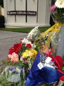 Flowers were placed at St. James Catholic Church on Dec. 18, 2014, near the site of a crash that killed three people the previous night. (Credit: KTLA)