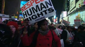 A woman is pictured protesting in Times Square Wednesday, Dec. 3, 2014, over the Grand Jury decision on Eric Garner. (Credit: CNN)