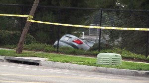 A car involved in a fatal crash in Irvine came to a stop over an embankment. (Credit: KTLA)