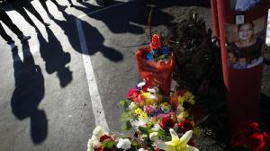 Family members gather at a memorial for Daniella Palacios, a 44-year-old mother of eight, who was struck and killed by a hit-and-run driver as she rode her bicycle in Anaheim in November 2014. (Credit: Barbara Davidson/Los Angeles Times)