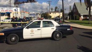 A squad car is seen in Mid-City following a triple shooting that left three people in critical condition on Wednesday, Dec. 17, 2014. (Credit: KTLA)