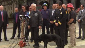 An accelerant-detection K-9 stood with federal and  local investigators at a news conference Dec. 10, 2014. (Credit: KTLA)