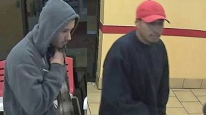 Two alleged armed robbers are seen in a surveillance image released by the Santa Ana Police Department on Tuesday, Dec. 23, 2014. 