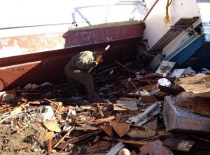 Search and rescue personnel worked to free a body from boat debris in Avalon Harbor on Dec. 31, 2014. (Credit: LASD)