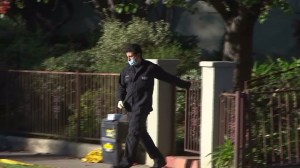 An investigator on Dec. 23, 2014, leaves the home where Antonia Yager was found stabbed to death. (Credit: KTLA)