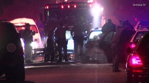 A homicide investigation was underway after a man was fatally shot inside his car at an intersection in East Compton on Dec. 23, 2014. (Credit: OnScene TV)