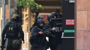 Armed police are seen outside the Lindt Cafe, Martin Place on Dec. 15, 2014, in Sydney, Australia. (Credit: Mark Metcalfe/Getty Images)