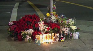 Candles, flowers and stuffed animal were left on the corner of PCH and Vincent Street. (Credit: KTLA)