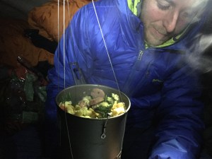 Tommy Caldwell eating dinner on the side on the Dawn Wall on Dec. 29, 2014.  (Credit: Kevin Jorgeson via Adidas Outdoor)