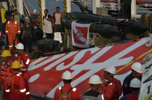 Indonesian crew of the Crest Onyx ship prepare to hoist recovered wreckage of AirAsia flight QZ8501 at port in Kumai on Sunday, Jan. 11, 2015. (Credit: Adek Berry/AFP/Getty Images)