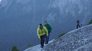 Kevin Jorgeson, shown in yellow, and Tommy Caldwell, in green, hiking up the summit towards the crowd after they completed their ascent of the Dawn Wall on Jan. 14, 2015. (Credit: Ted Distel / Adidas Outdoor)