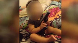 An Indiana couple was arrested after cellphone video emerged of a baby girl playing with an apparently real handgun, police say. (Credit: Evansville Police Department via CNN) 