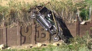 The mangled wreckage was pulled up from below the 118 Freeway on Jan. 25, 2015. (Credit: KTLA) 