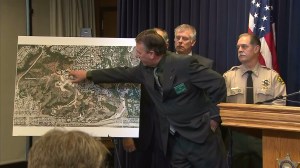 L.A. County Sheriff’s Department Homicide Division Lt. Dave Coleman points to the site of a homicide above La Verne at a news conference on Jan. 7, 2015. (Credit: KTLA)