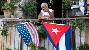 A Cuban gives the thumbs up from his balcony decorated with the US and Cuban flags in Havana, on Friday, Jan. 16, 2015. (Credit: Yamil Lage/AFP/Getty Images)