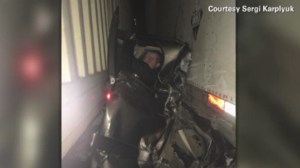 This dramatic photograph captured driver Kaleb Whitby pinned between two big rigs following a pile-up in Oregon. (Credit: Sergi Karplyuk via CNN) 