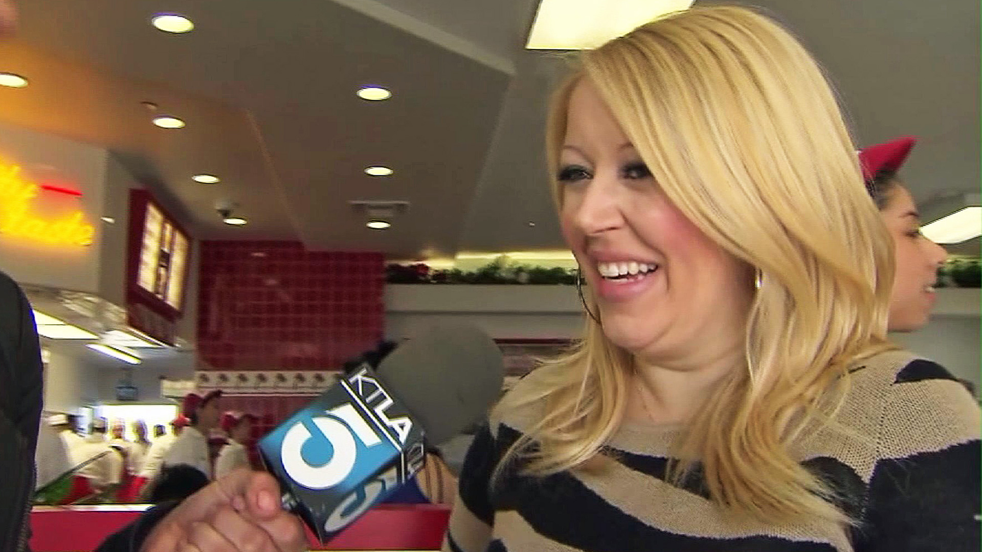 In-N-Out Burger owner Lynsi Snyder laughs after being asked about adding chicken to the menu. (Credit: KTLA)