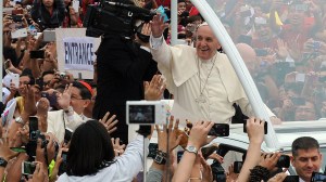 Pope Francis waves as he arrives at the University of Santo Tomas during his visit to Manila on Sunday, Jan. 18, 2015. (Credit: Jay Directo/AFP/Getty Images)