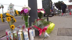 A memorial was growing  Jan. 20, 2015, at the site where Lexi and Eli Garcia died in a high-speed crash in Wilmington. (Credit: KTLA)