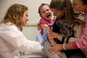 A doctor administers a measles vaccination to a 4-year-old as her mother holds her in this file photo taken at Miami Children's Hospital on Jan. 28, 2015. (Credit: Joe Raedle/Getty Images)