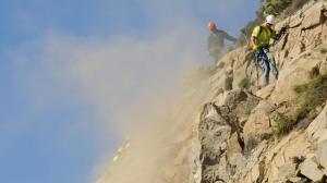 Work crews rappel down a cliff to remove loose rocks above Pacific Coast Highway in Malibu on Jan. 6, 2015. (Credit: Wally Skaij / Los Angeles Times)