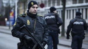 A police officer guards the street around the Noerrebro train station in Copenhagen on Sunday, Feb. 15, 2015. A man was shot in a police action following two fatal attacks in the Danish capital. (Credit: Claus Bjorn Larsen/AFP/Getty Images)