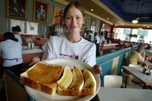 Arcade restaurant waitress Julia Flowers holds a peanut butter and banana sandwich, Elvis Presley's favorite snack, on the 25th anniversary of Presley's death during Elvis Week in August 2002 in Memphis, Tennessee. (Credit: Mario Tama/Getty Images)