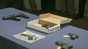 After the shooting of Jamar Nicholson, police  on Feb. 12, 2015, display replica handguns including the one -- in a box -- that Nicholson's friend was allegedly holding. (Credit: KTLA)