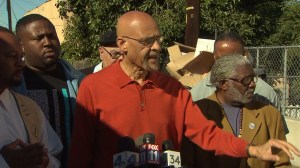 Earl Ofari Hutchinson is on Feb. 13, 2015, backed by other activists in calling for police training in the wake of the shooting of Jamar Nicholson. (Credit: KTLA)