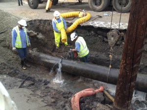 Workers prepare to remove a section of water main after a break occurred Feb. 18, 2015. (Credit: Kareen Wynter/KTLA)