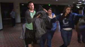 Truck driver Jose Alejandro Sanchez-Ramirez leaves jail with jacket covering his head after no charges were filed against him in the Oxnard Metrolink crash. (Credit: KTLA)