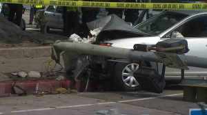 A light pole and signal were downed after a vehicle struck them and four near USC on Feb. 26, 2015. (Credit: KTLA)