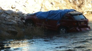 A woman was killed and her 18-month-old daughter was in critical condition after a car crashed into the Spanish Fork river in Utah and was found about 13 hours later. (Credit: KSTU)