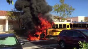 A witness's video showed a school bus engulfed in flames outside a middle school in Rancho Santa Margarita on Friday, March 27, 2015. (Credit: David Fogal)