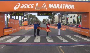 Kenyan Daniel Limo, 31, crosses the L.A. Marathon finish line on Sunday, March 15, 2015. (Credit: KTLA)