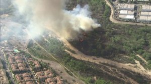 A brush fire was burning close to homes in Santa Clarita on March 23, 2015. (Credit: KTLA)