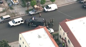 A man wounded in a shootout with deputies surrendered after an hour-long standoff in South L.A. on Friday, March 13, 2015. (Credit: KTLA)