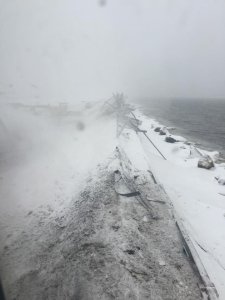 A Delta airplane slid off a runway late Thursday morning at New York's LaGuardia airport, its nose busting through a fence before skidding to a halt mere feet from icy waters. (Credit: Jared Faellaci via CNN Wire)