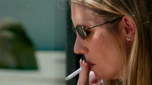 A woman lights up a cigarette at a garden in Costa Mesa. (Credit: Karen Tapia-Andersen/Los Angeles Times)