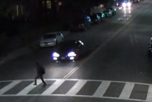 A still from surveillance video released by LAPD shows a vehicle speeding toward Elias Aceves, who was killed March 10, 2015, near USC.