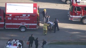 A man was wheeled away by stretcher into an ambulance following a stabbing in Van Nuys on March 24, 2015.  (Credit: KTLA) 