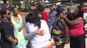 People could be seen grieving after a couple died in an apparent murder-suicide in Carson on April 12, 2015. (Credit: KTLA)