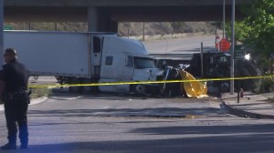Hours after the fatal crash below the 210 Freeway on April 17, 2015, investigators remained on scene. (Credit: KTLA)