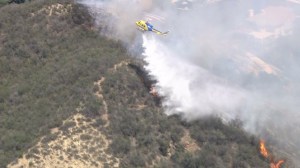 water-dropping helicopter works a Ventura County fire on April 30, 2015. (Credit: KTLA)